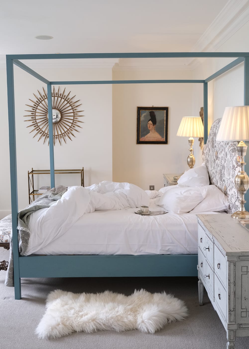 Bedroom at Thyme with ruffled sheets and a fluffy rug beside the bed