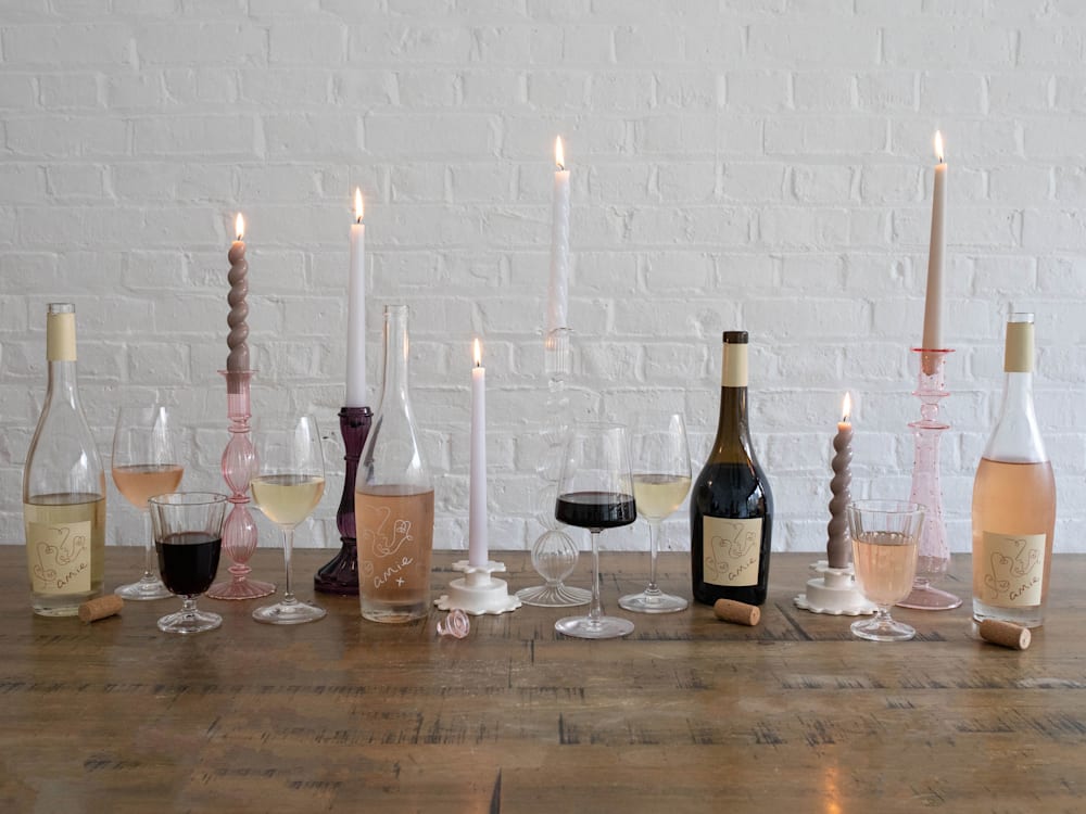Rose, red and white wines on table with candles