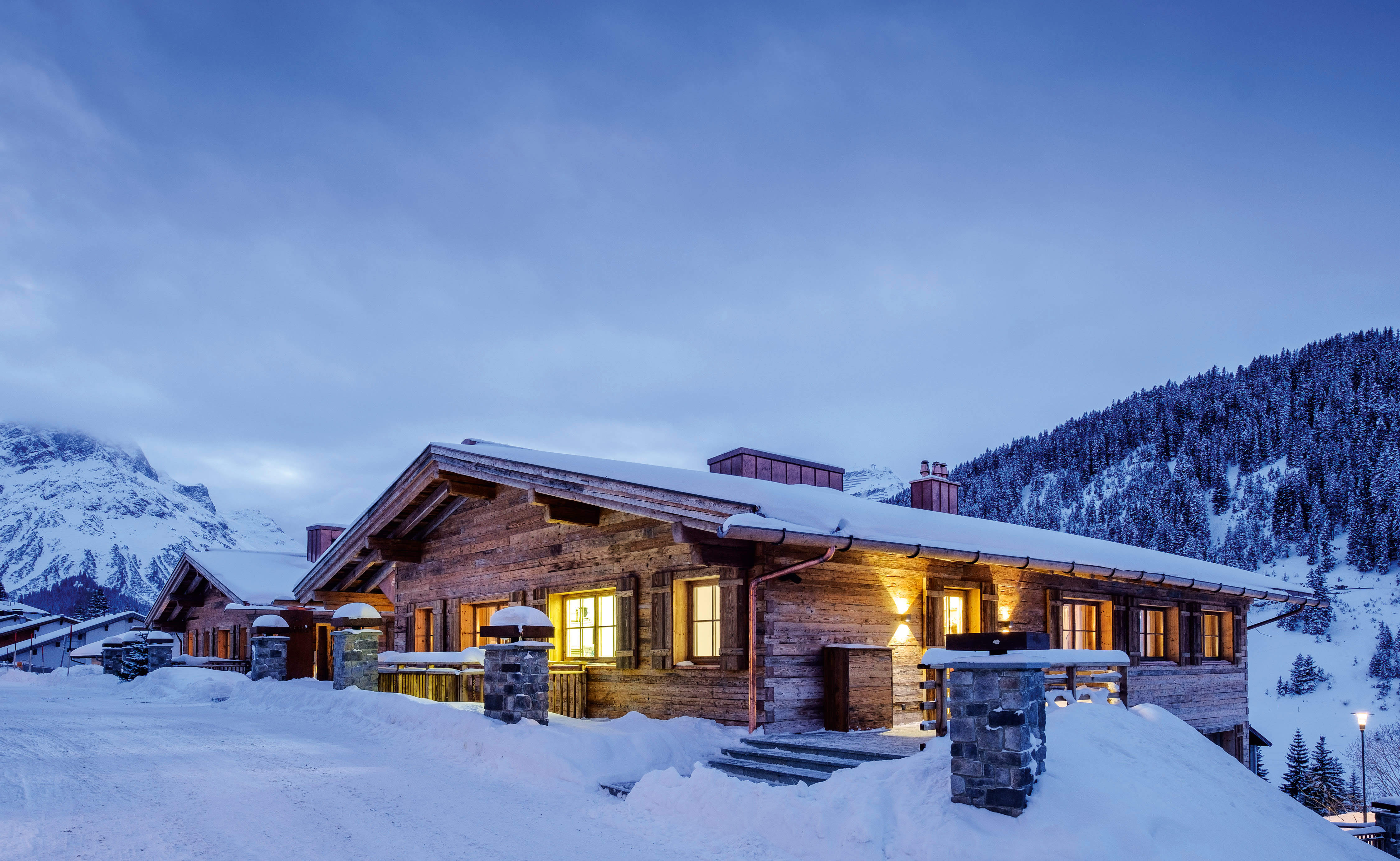exterior view of ski chalet in the mountains covered in snow