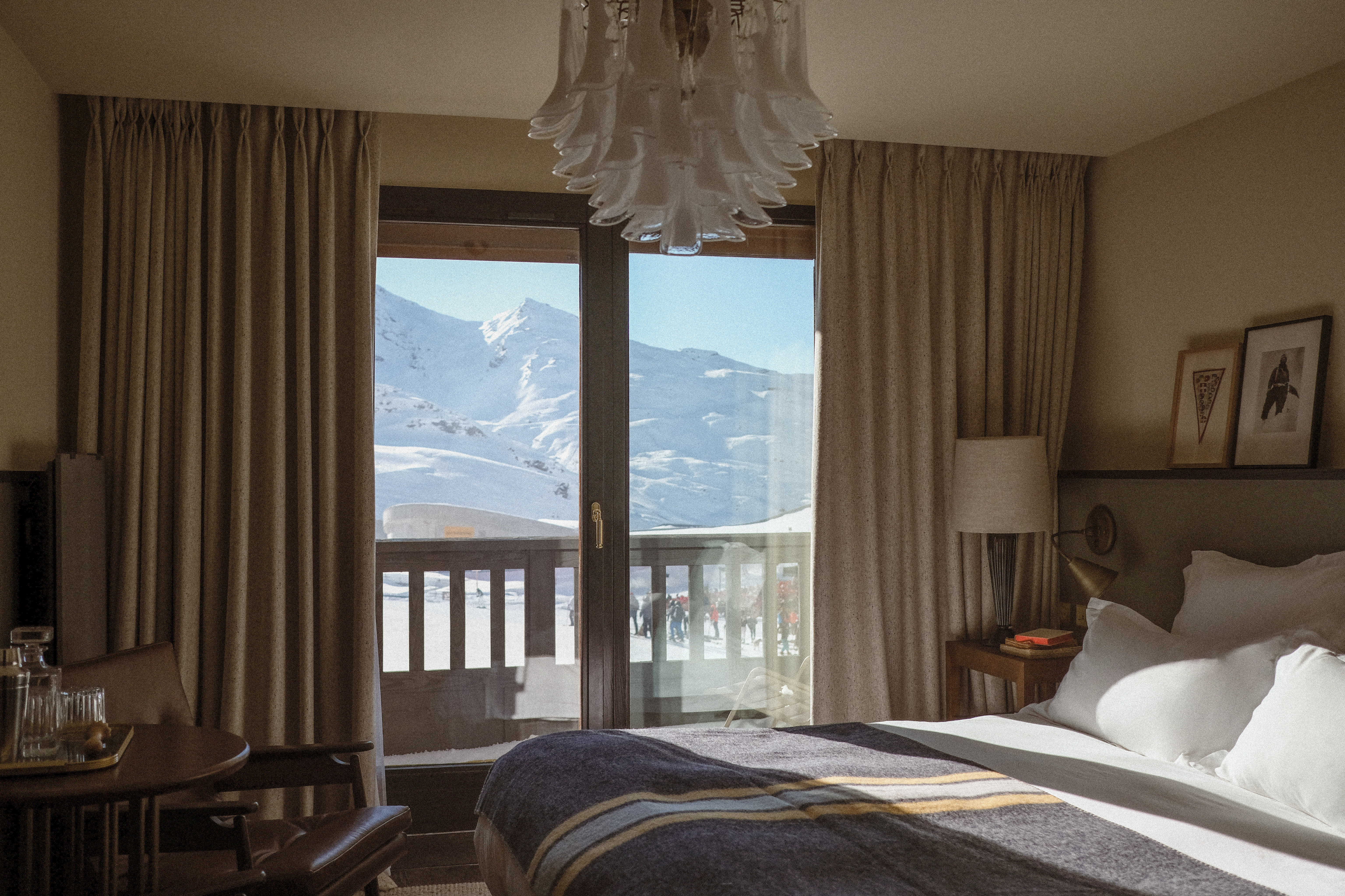 a hotel room overlooking the ski slopes and mountains