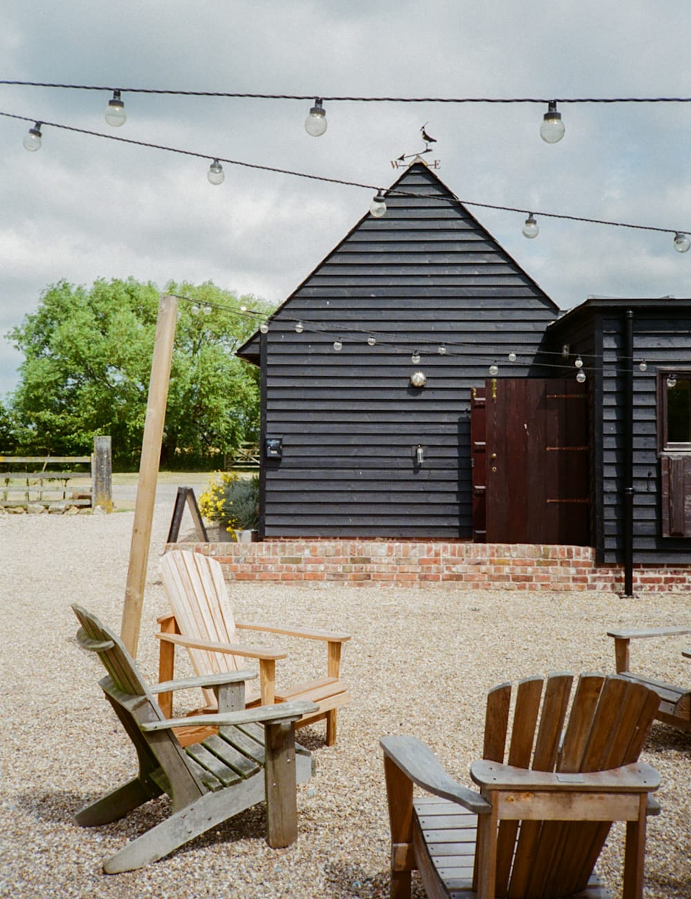 Outdoor seating under festoon lighting at Elmley Nature Reserve, Kent