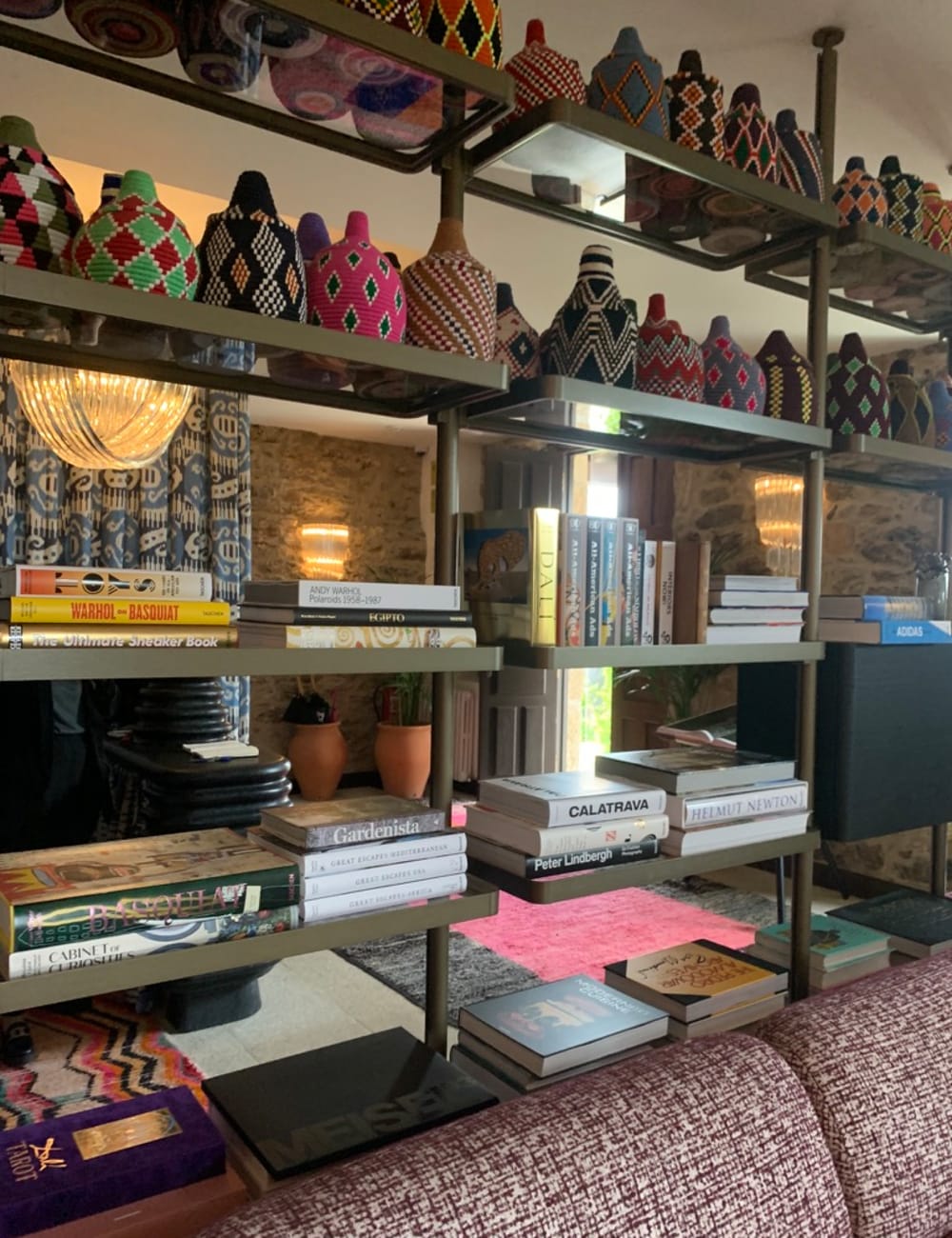 Bright material-clad pots and shelves full of design books at Casa Beatnik hotel