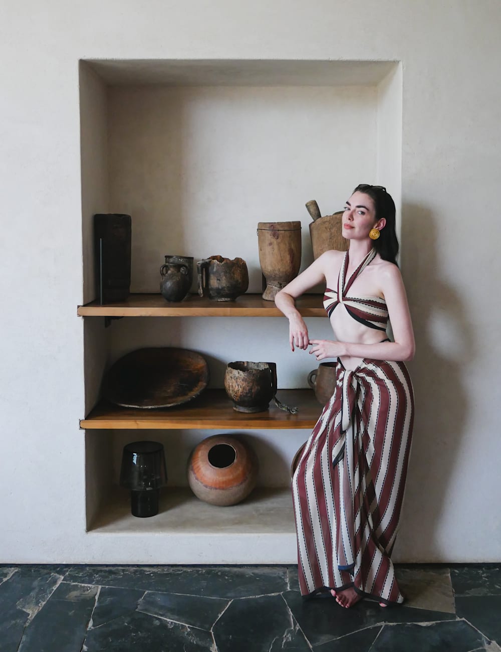 Zoë Zimmer wearing the 87 by a shelf of decorative pots, by Richard MacKichan for Mr & Mrs Smith