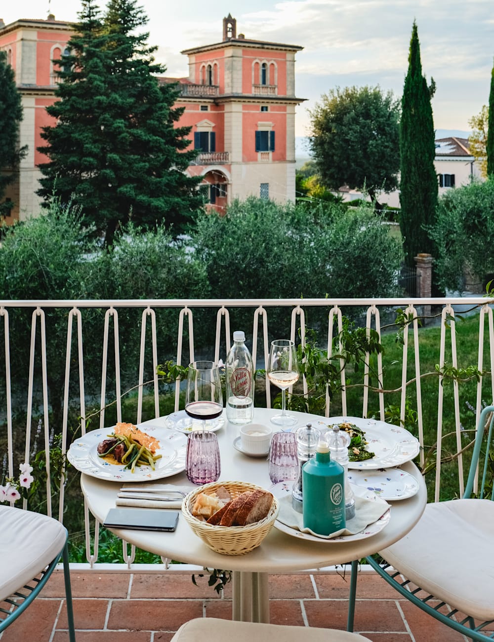 Meal for two served outside on a terrace at Villa Lena hotel, Tuscany