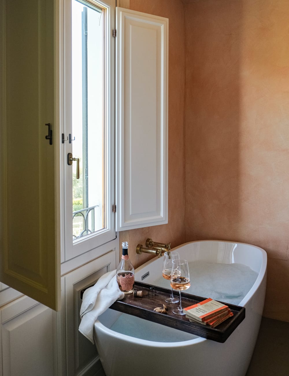 Wine for two in a filled bathtub at Villa Lena hotel, Tuscany