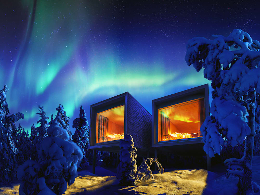 Hotel exterior in the snow with the northern lights in the sky