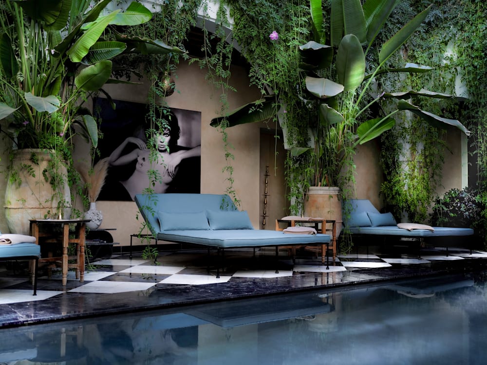 The courtyard swimming pool and sunbeds are surrounded with jungle like plants for a tropical feeling oasis