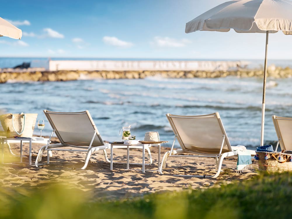 Sun loungers and parasol on the beach in the Spanish sunshine