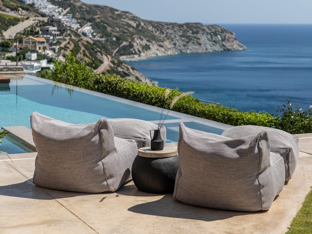 Two sun loungers looking out over the pool and the cliff side and ocean at Villa Octo, Crete