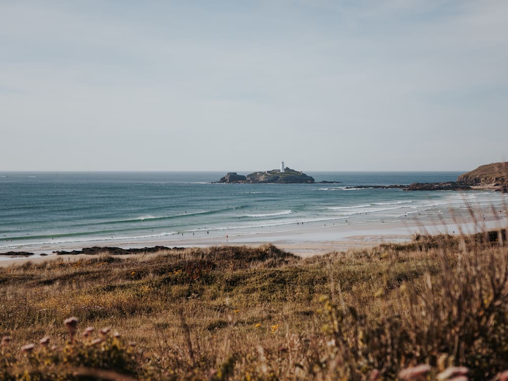 View of the beach with the lighthouse in the distance