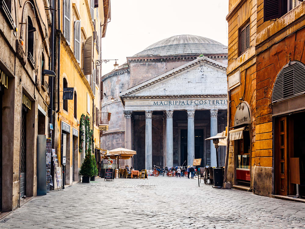 Old cobblestone street in Rome and Pantheon in Italy
