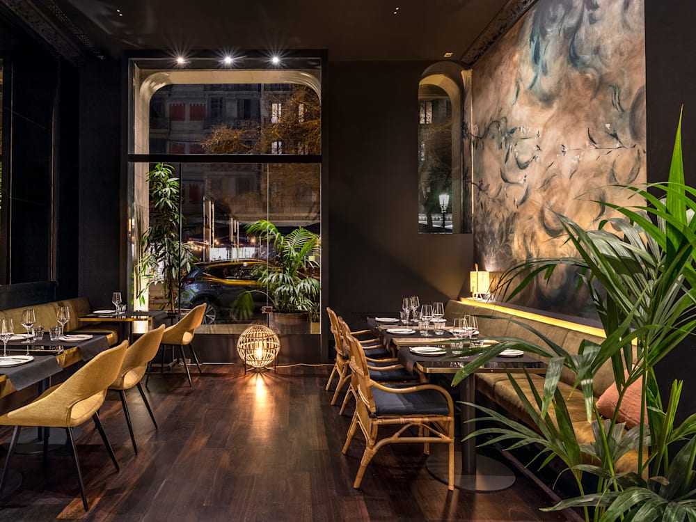 Dining area at Casa Sagnier with patterned wallpaper and velvet chairs