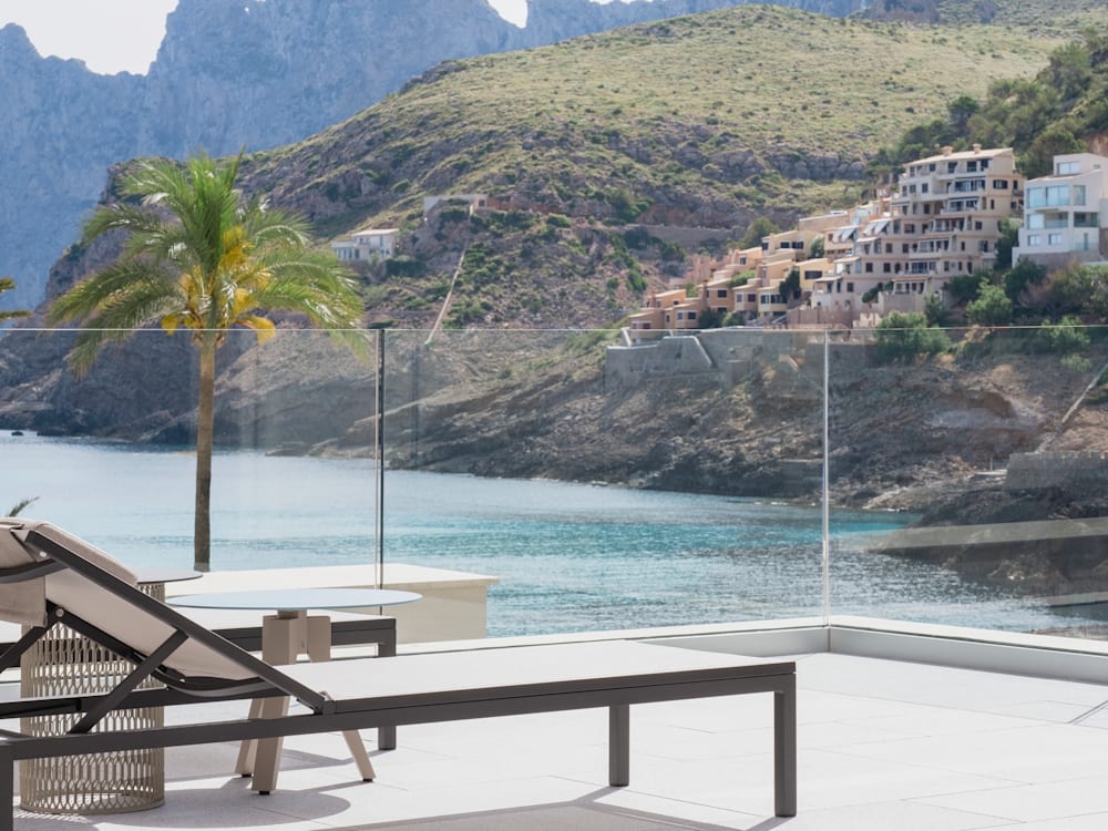 Sun loungers on the terrace looking out to the mountains and the sea