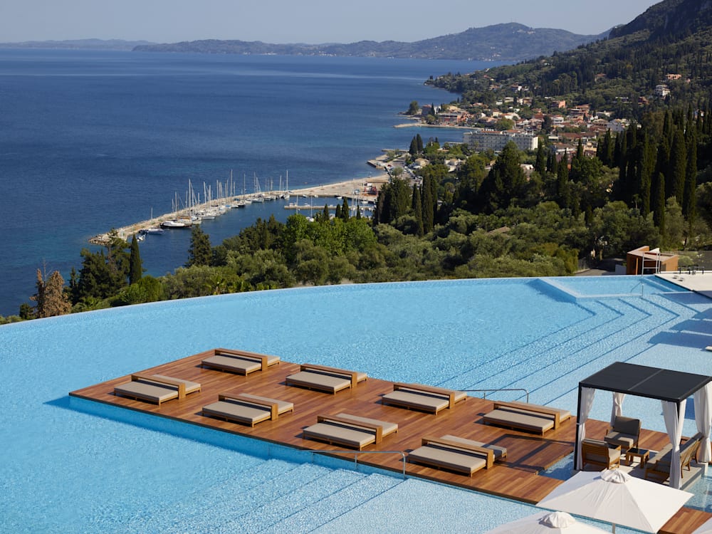 Infinity pool on the edge of the cliff overlooking the ocean and the town