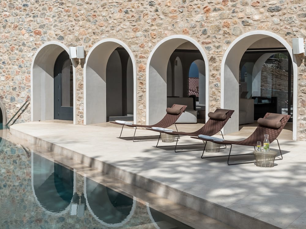 Sun loungers by the pool at Euphoria Retreat hotel in Greece 