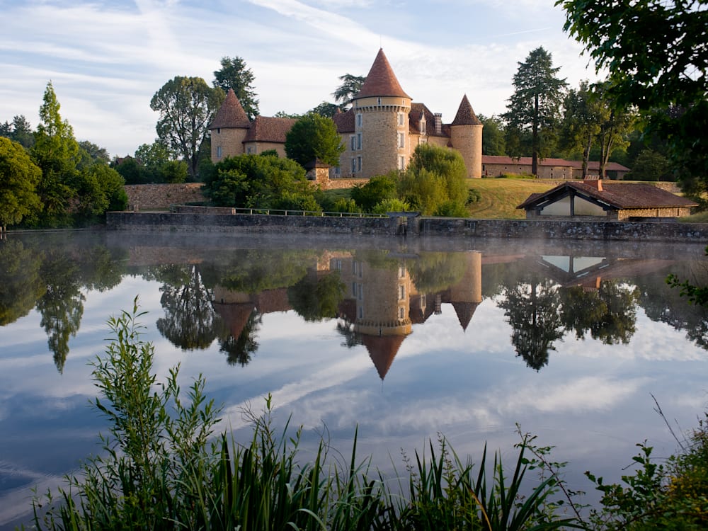 The view of the chateau over the lake - the reflection in the water is crystal clear as the terracotta turrets are nested in amongst the trees and greenery