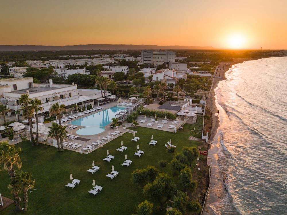 Aerial photograph of the hotel on the beach, sun setting in the distance