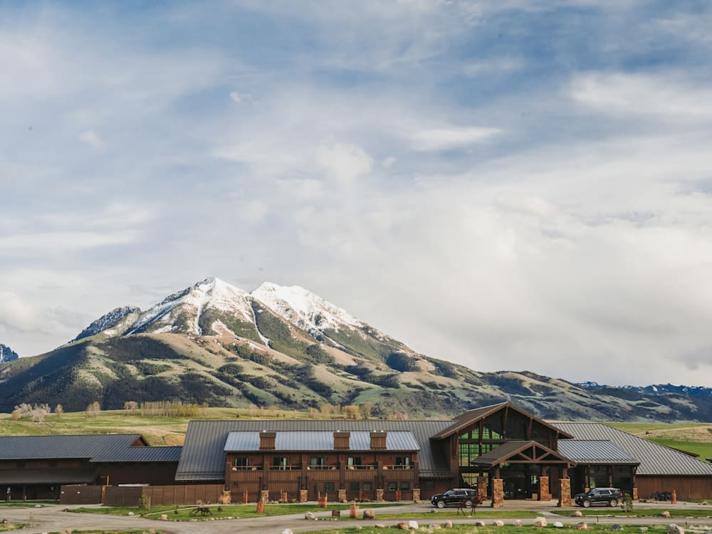 Exterior of hotel with views of snow capped mountains in the background