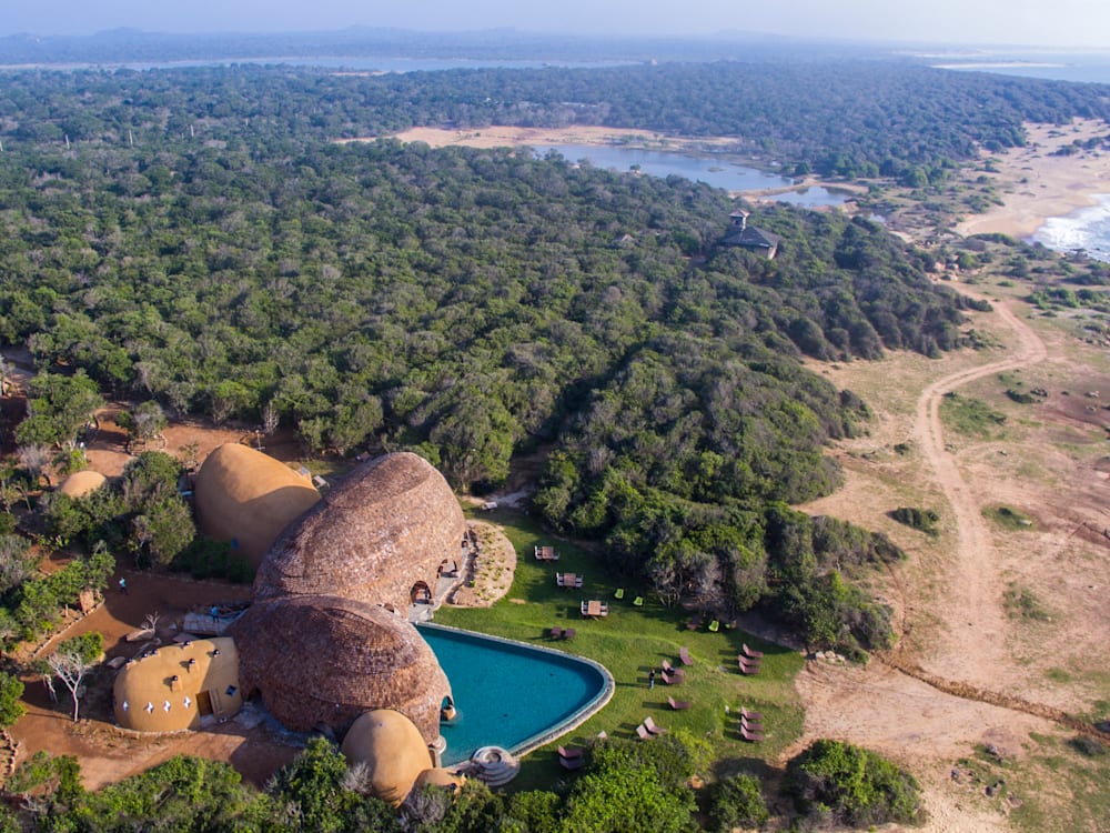 Aerial view of the property, the swimming pool, the surrounding wilds and rocky coastal region