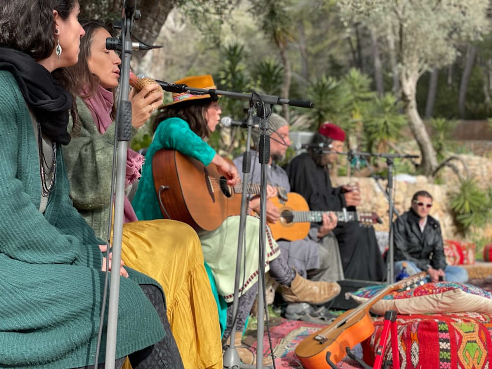 Group of people singing and playing guitar in Ibiza