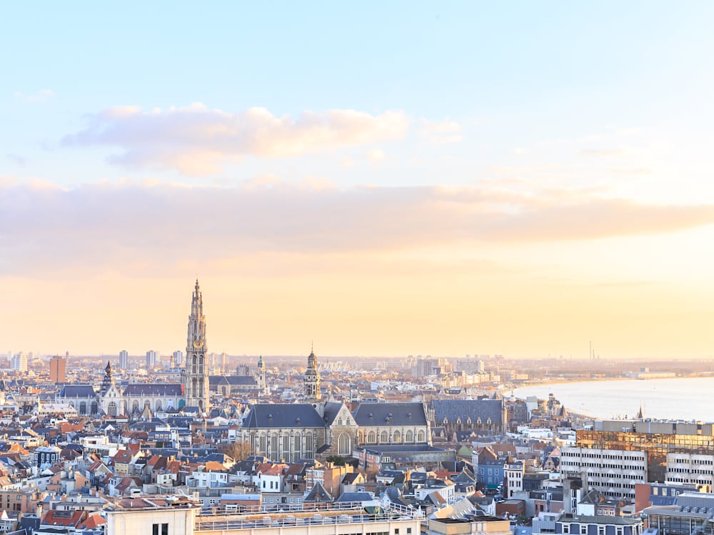 Sunset over the skyline of Antwerp. The cathedral spire is the dominant building in the picture