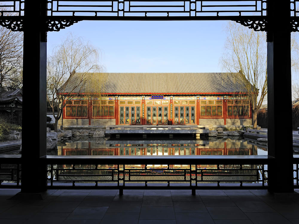 Exterior of the hotel glinting red and gold in the sunlight from the pavilion