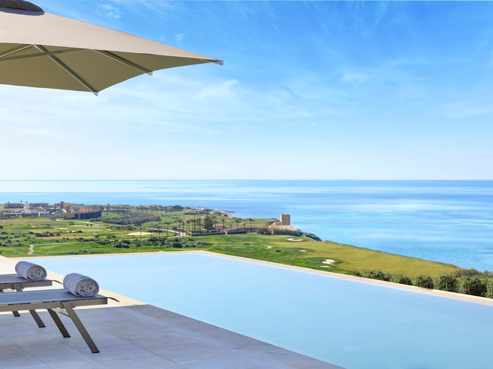 Swimming pool overlooking the clifftops to the ocean at Rocco Forte private villas, Sicily 