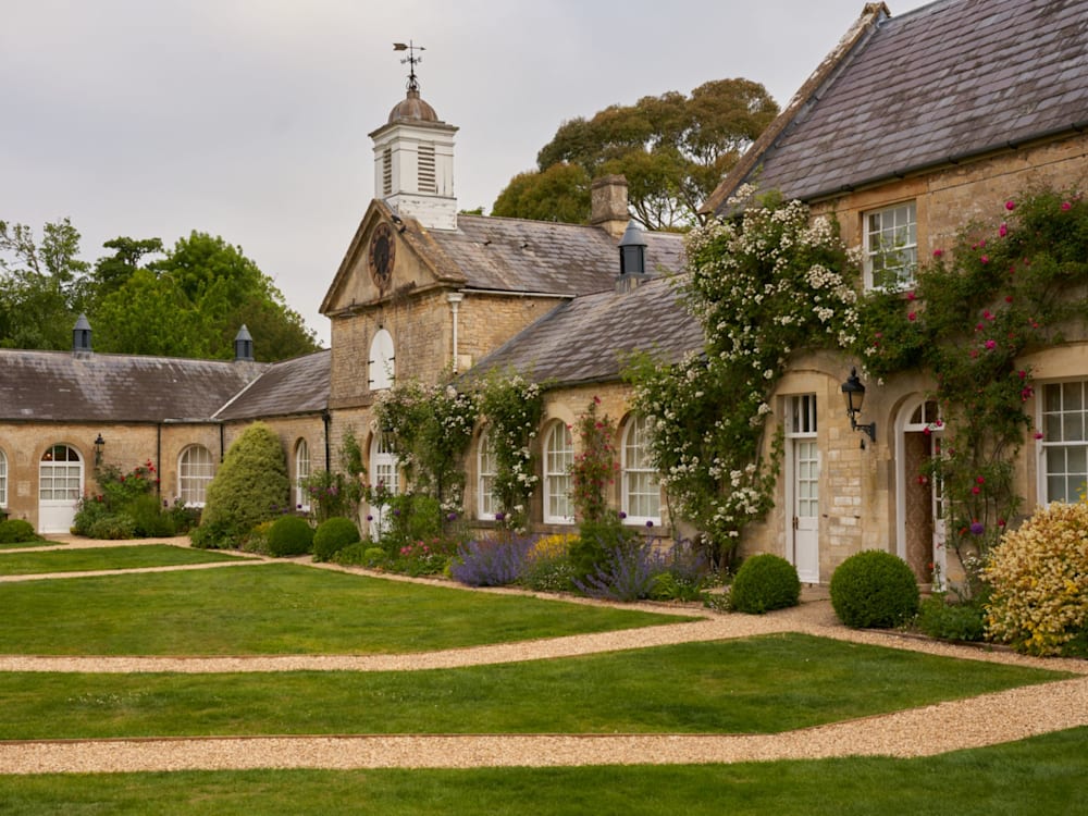 Hotel exterior and courtyard with plumbing roses