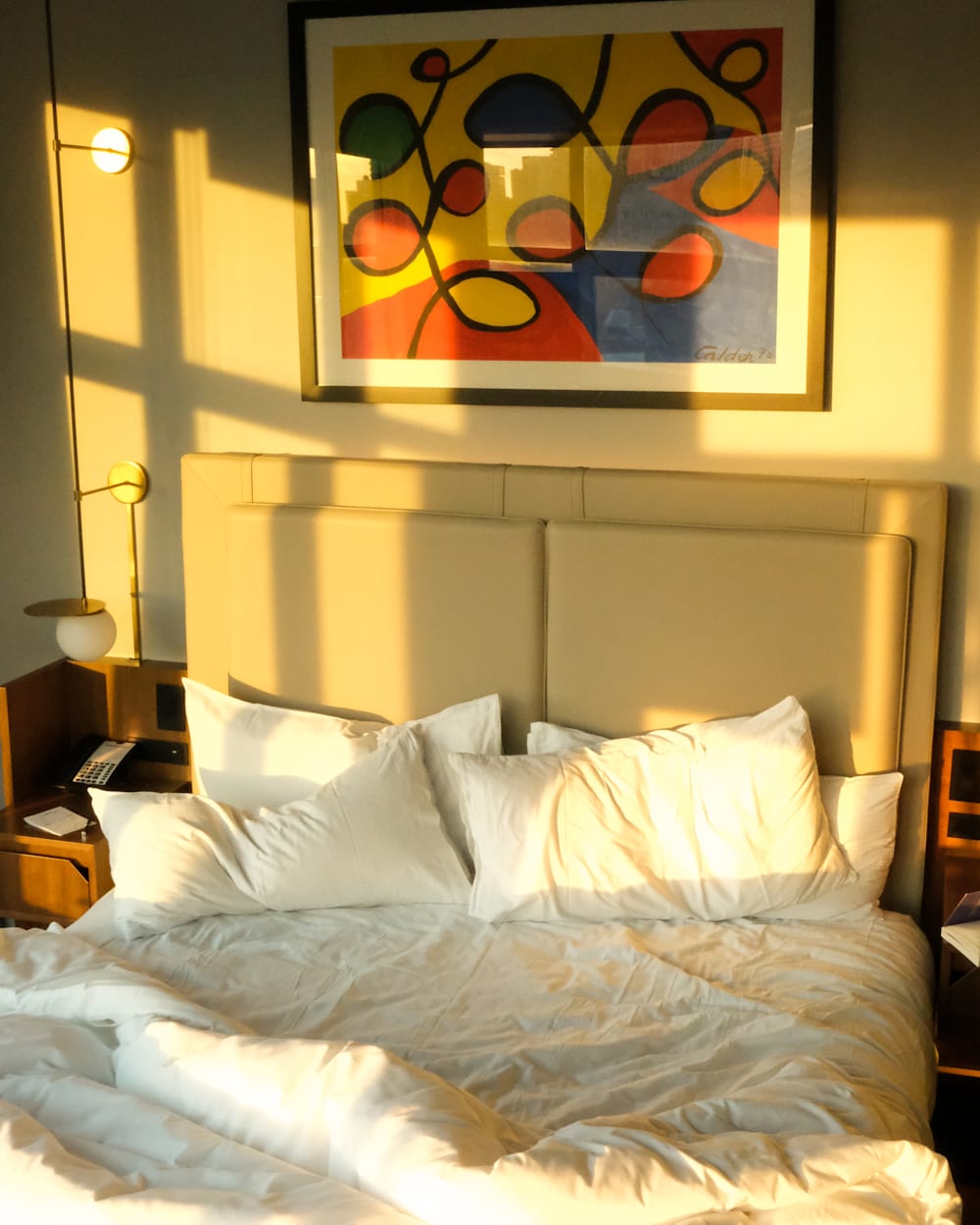 ModernHaus Soho bedroom with sunlight creating shadows on the wall