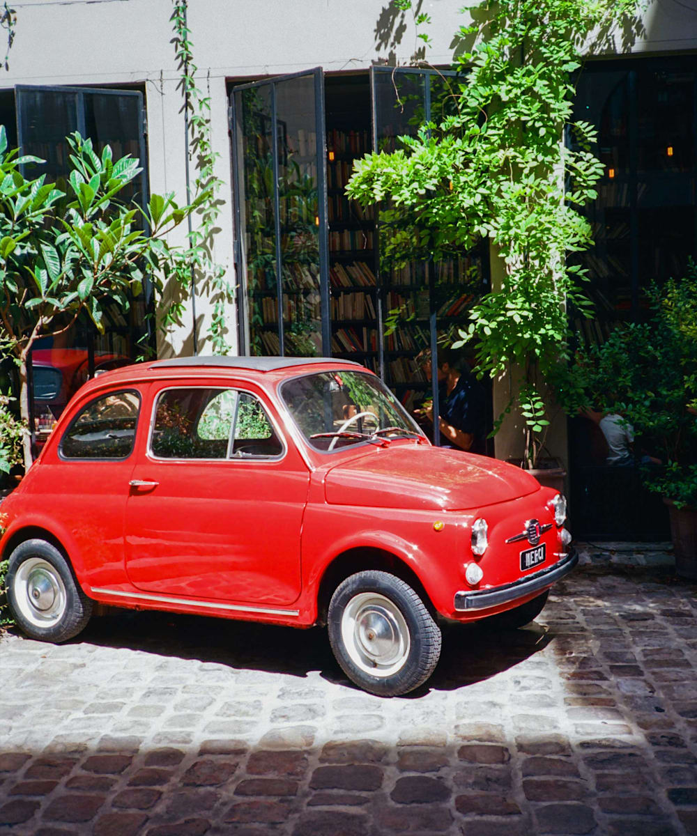 Red fiat sits outside Merci store in Paris