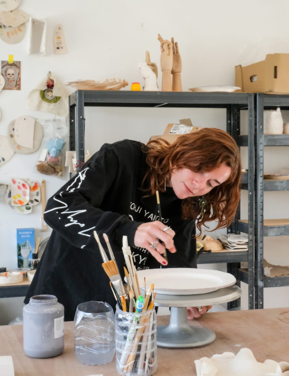 Artist Alma Berrow decorating a plate in her studio by Michaela Watkinson for Mr & Mrs Smith